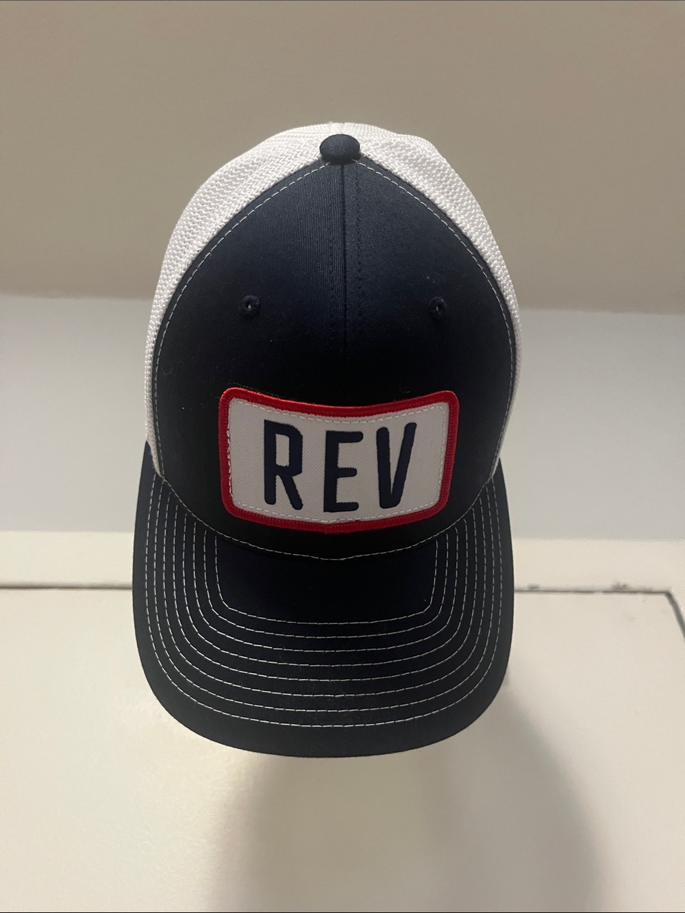 REV Patch Trucker Hat - Navy Front with White Mesh